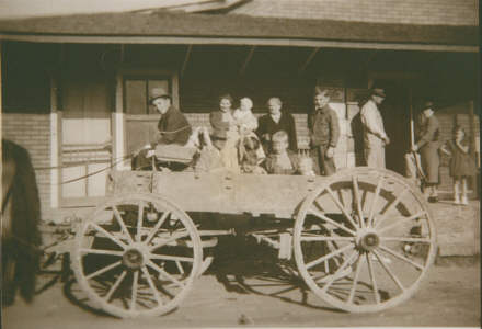  Farmer's Exchange - Wendy in wagon, Ruth & baby Carolyn, Grandma Graves, Donald, Maurice, Marvin, Mr. Melton Hensley, Aunt Minnie and Wyrick girl 